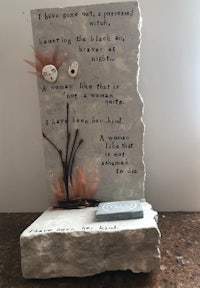 a stone sculpture with a poem on it