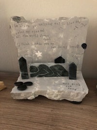 a stone sculpture with a poem on it