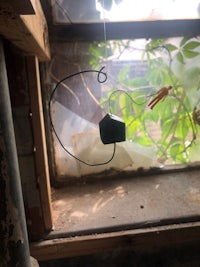 a wire hanging from a window sill