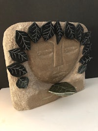 a statue of a woman with leaves on it