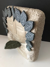 a statue of a woman with leaves on it