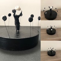 a series of black and white sculptures on top of a table