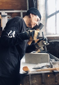 a man working with a tool in a workshop